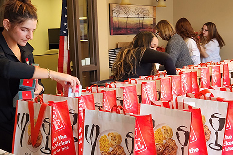 Wegmans School of Nursing students pack bags of food for the community.