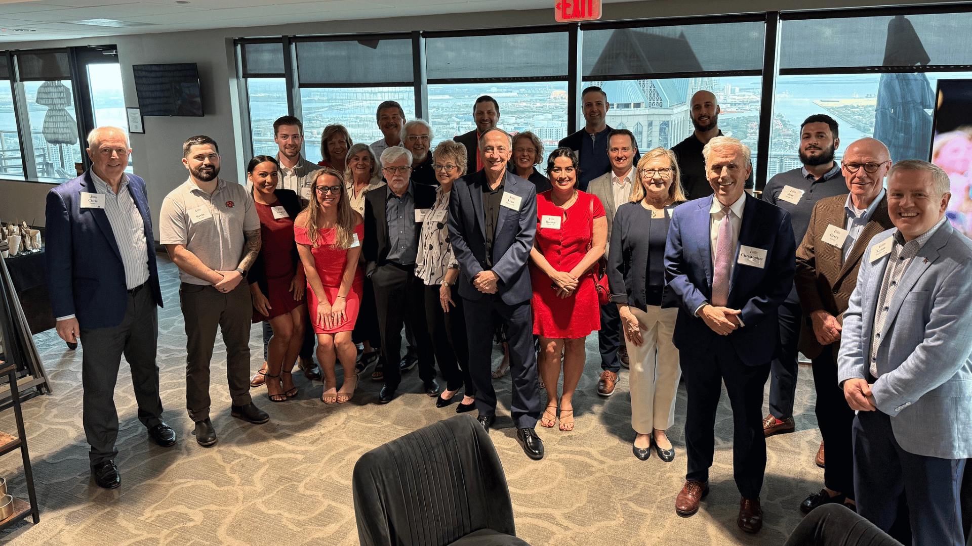 A group of Fisher alumni gather for a photo at an alumni reception
