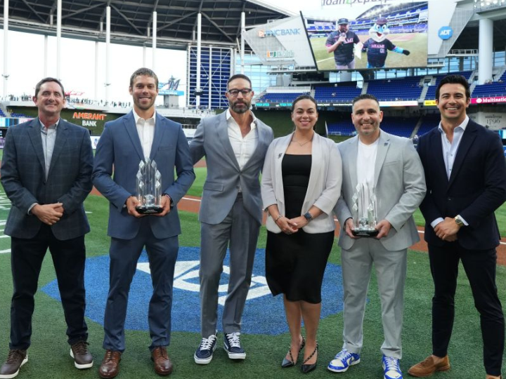 Tim Sylvester holding the 2025 Jackie Robinson Award with a fellow honoree and professional staff