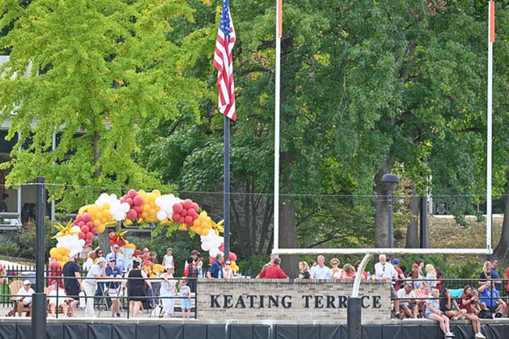 A distance photo of an outdoor terrace with people mingling