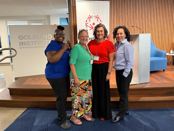 Celia McIntosh, Sarah Ailey, Elizabeth Dollinger, and Holly Brown standing shoulder to shoulder