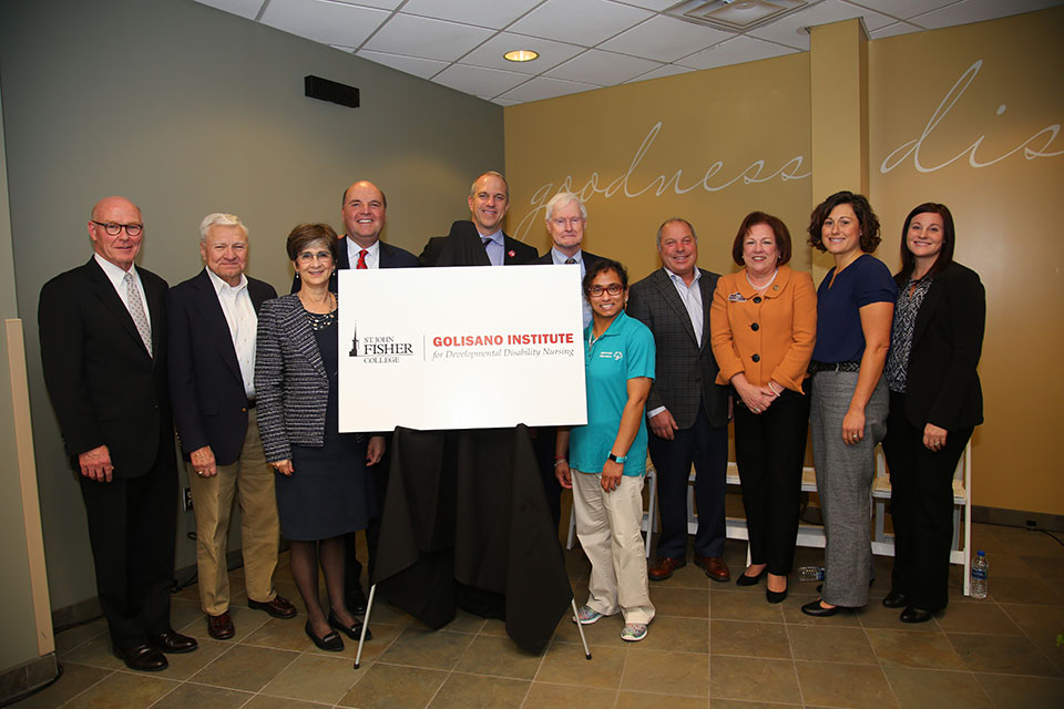 President Rooney; Ann Costello, Golisano Foundation; Drew Boshell, Special Olympics; Cori Piels, Special Olympics; Dr. Dianne Cooney Miner; Wegmans School of Nursing faculty; and Golisano Foundation trustees celebrate the newly announced Golisano Institute for Developmental Disability Nursing.