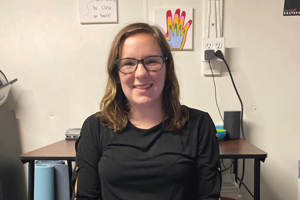 Emily Moore sits at a laptop in her room.