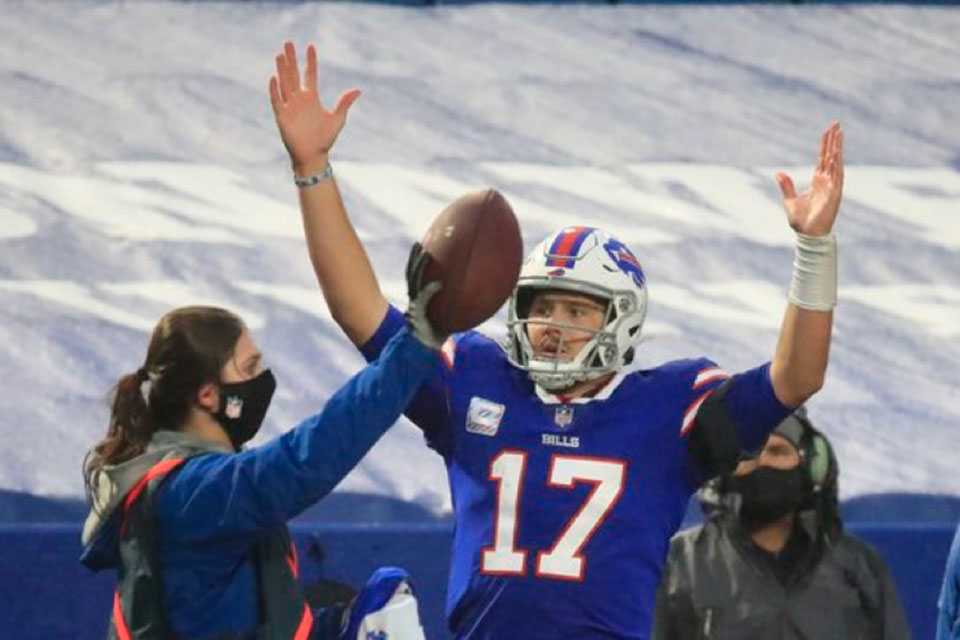 Fisher student Rachel Makowski helps Bills quarterback Josh Allen.