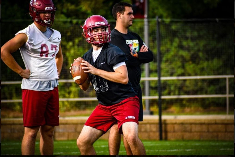 Cameron Dunn throws a ball during football practice.