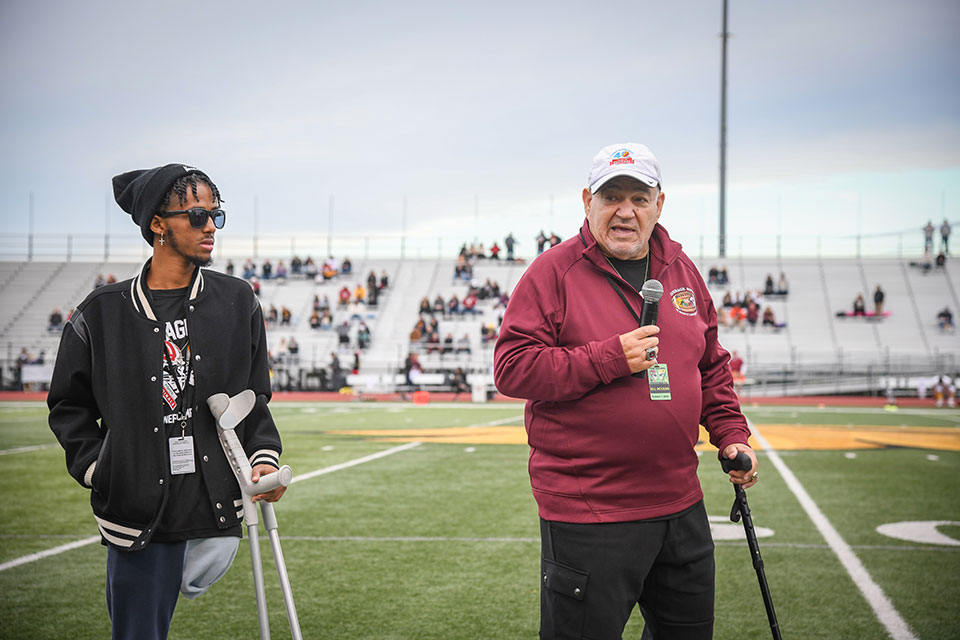 Gary Mervis (right) presents the Father Joe Lanzalaco Courage Award to a camper (left).