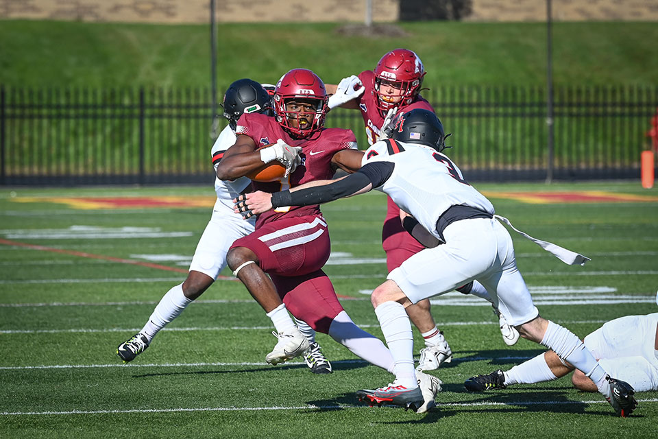 A Fisher football player runs the ball.