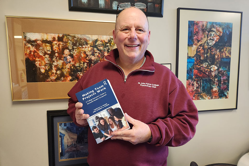 Dr. Timothy Franz poses with a copy of his new book.