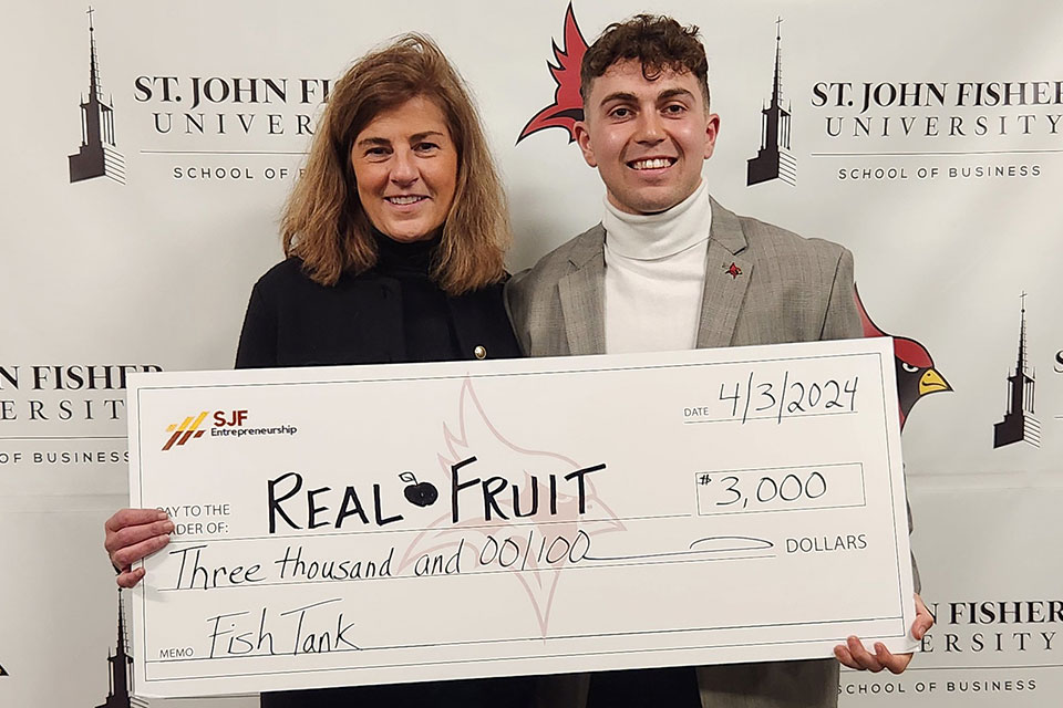 Spring Entrepreneurship Week FishTank Winner Caleb Thomas (right) with Rebecca Pelino (left).