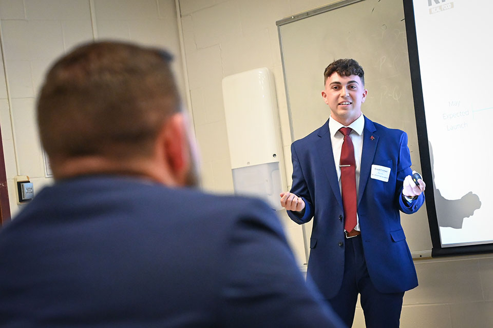 A student gives a presentation during a networking event.