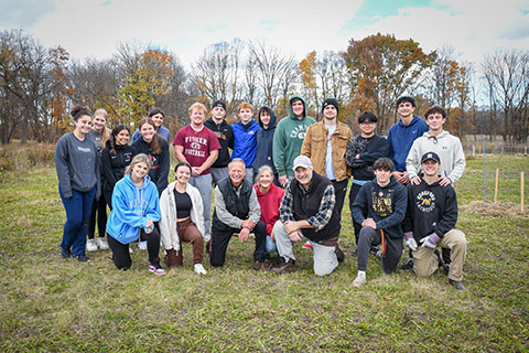 A group of first-year students with Professors Ron Sicker and David Kunsch at 100 Acre Woods.