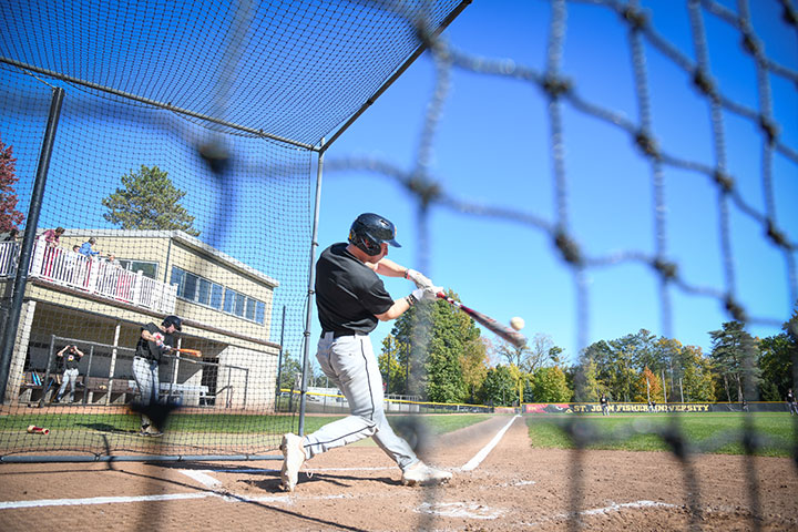 A baseball player hits the ball during the Home Run Derby.