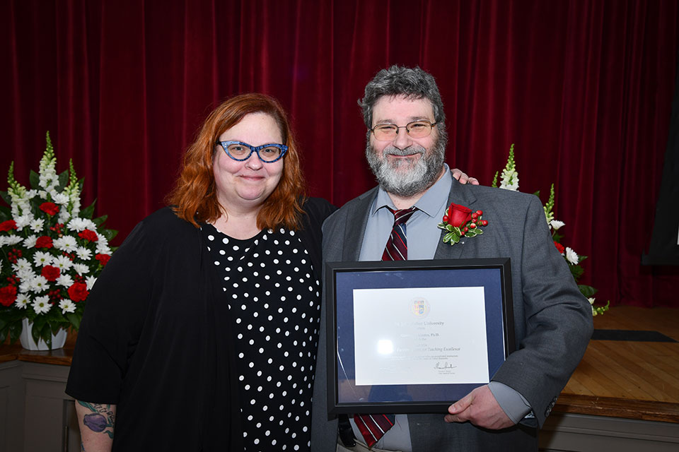 Dr. Joellen Maples gives an award to Dr. Guillermo Montes