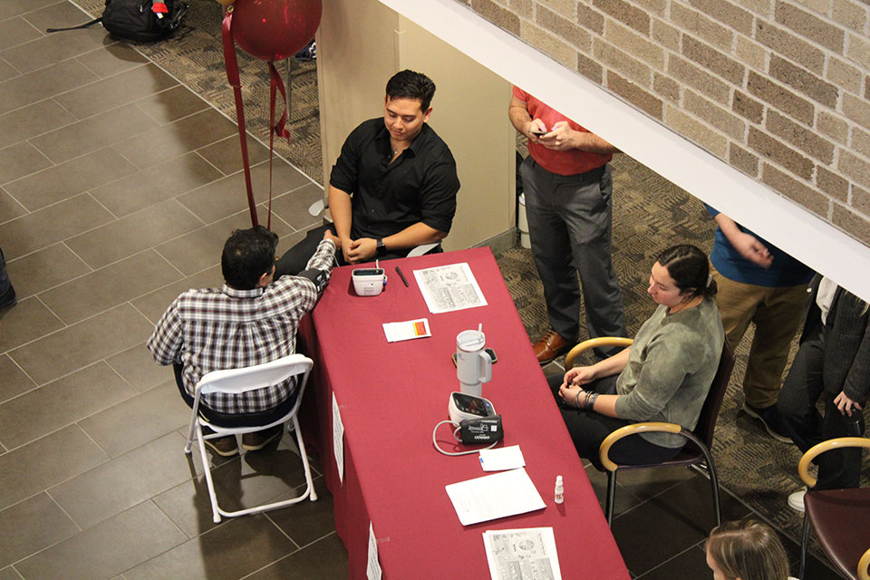 Students check blood pressure during the Pharmacy Month Health Fair.