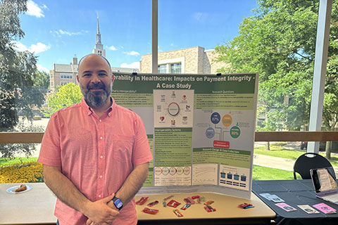 An ED.D. student presents a poster on proposed research about interoperability in health care.