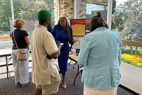 Ed.D. students share their research with guests at the Poster Presentation session.