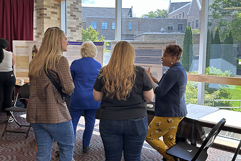 Ed.D. students share their research with guests at the Poster Presentation session.