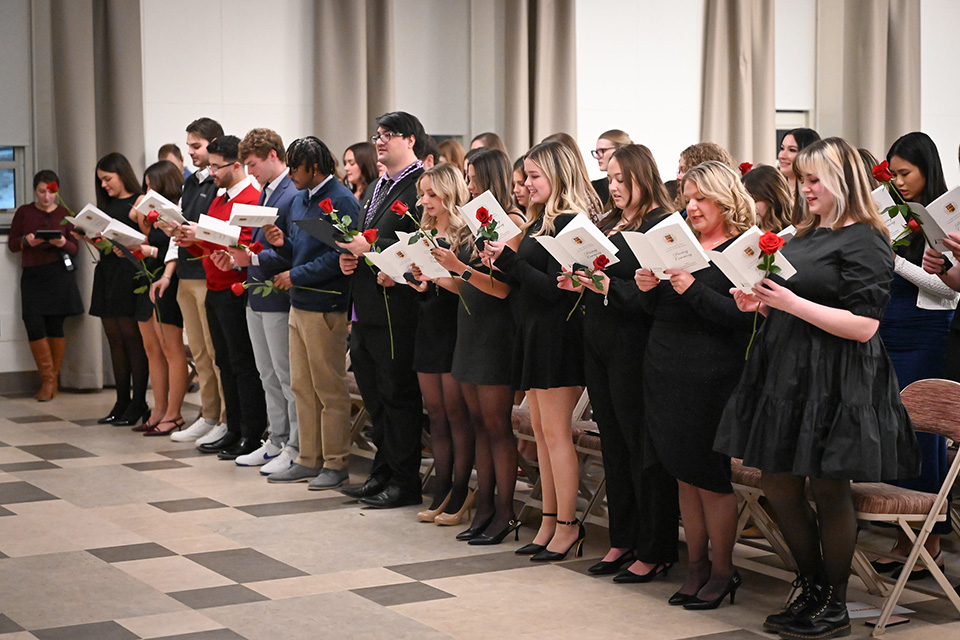 Nursing students stand during the pinning ceremony.