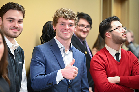 A student gives a thumbs up during the nursing pinning ceremony.