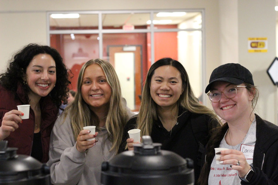 Four students sample coffee in Ward-Haffey Dining Hall.