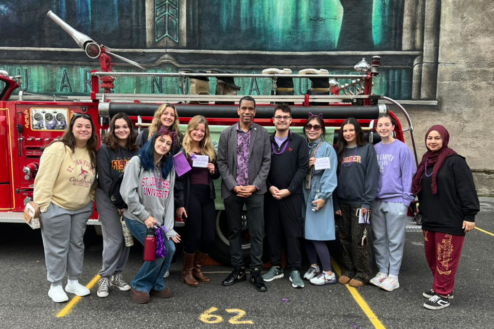 Students in the criminal justice course, Victimology, with Rochester Mayor Malik Evans at a community event.