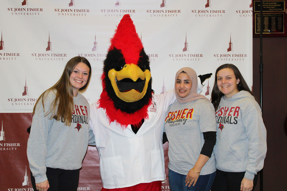 Students pose with Beaks during Pharmacy Week celebrations.