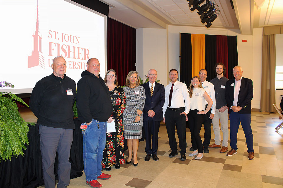 President Rooney with employees celebrating five years of service.