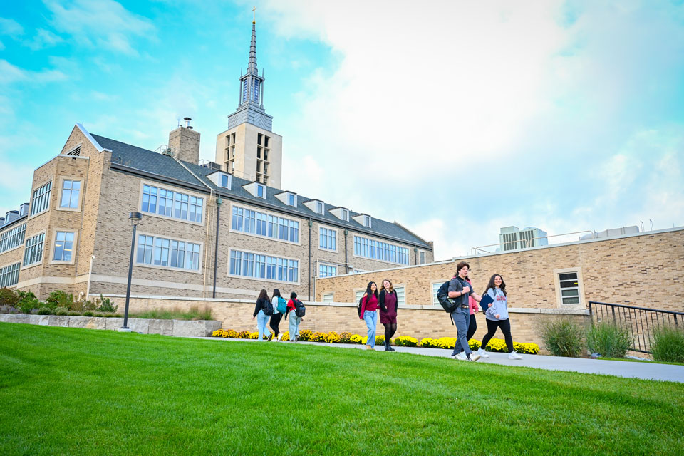 Students walk on campus between Lavery Library and Kearney Hall.