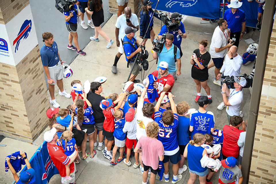 Aerial view of Buffalo Bills fans holding gear for an autograph.