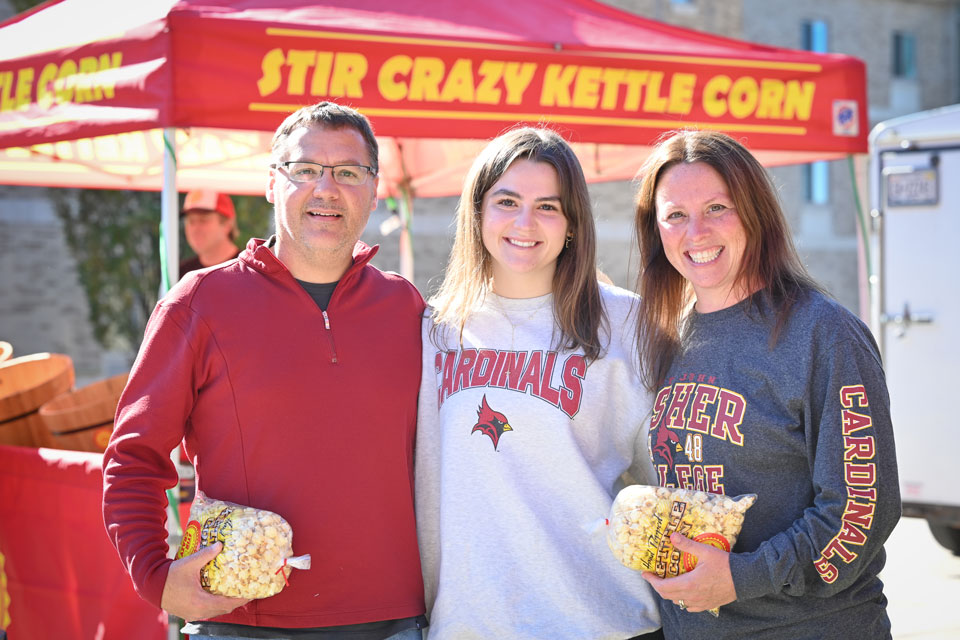 A Fisher family enjoy popcorn during Family Weekend.
