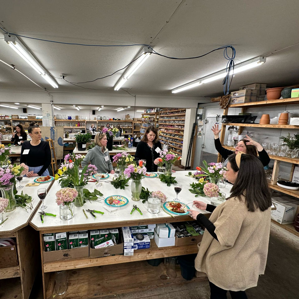 Women design their own floral arrangements during the first Blossoms and Beverages event.