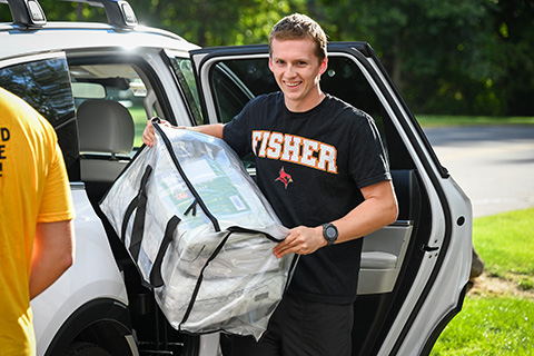 A student unloads his car on move-in day.