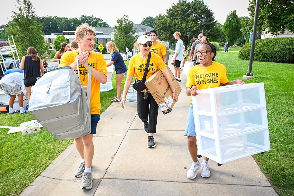 Mrs. Rooney and members of the Orientation Team moving students into the residence halls.