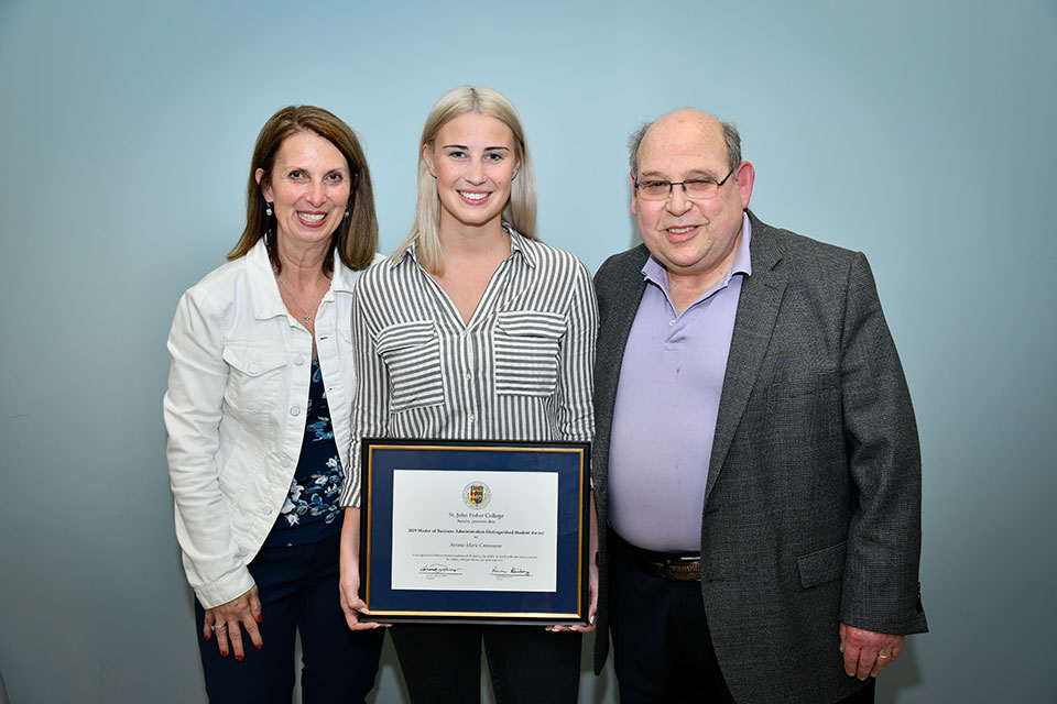 Aviana Catarasano (center) accepts an award during the School of Business celebration.