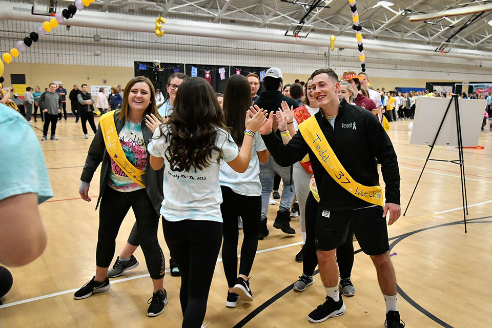 Tyler Adams (right) high-fives dancers at Teddi 37.