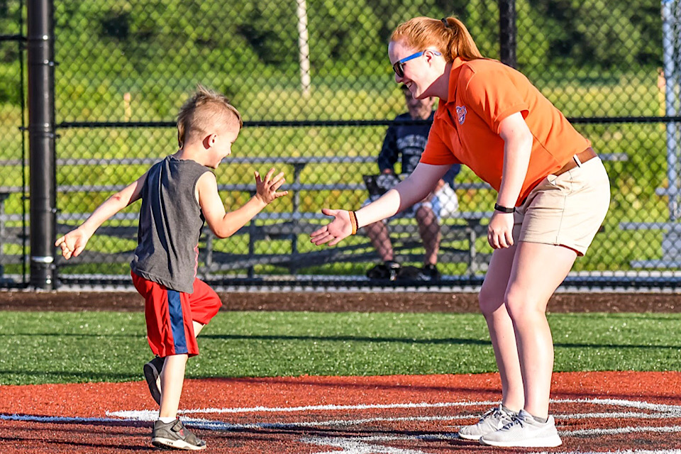 Fisher student Allison Osterhoudt high-fives a child during her internship.