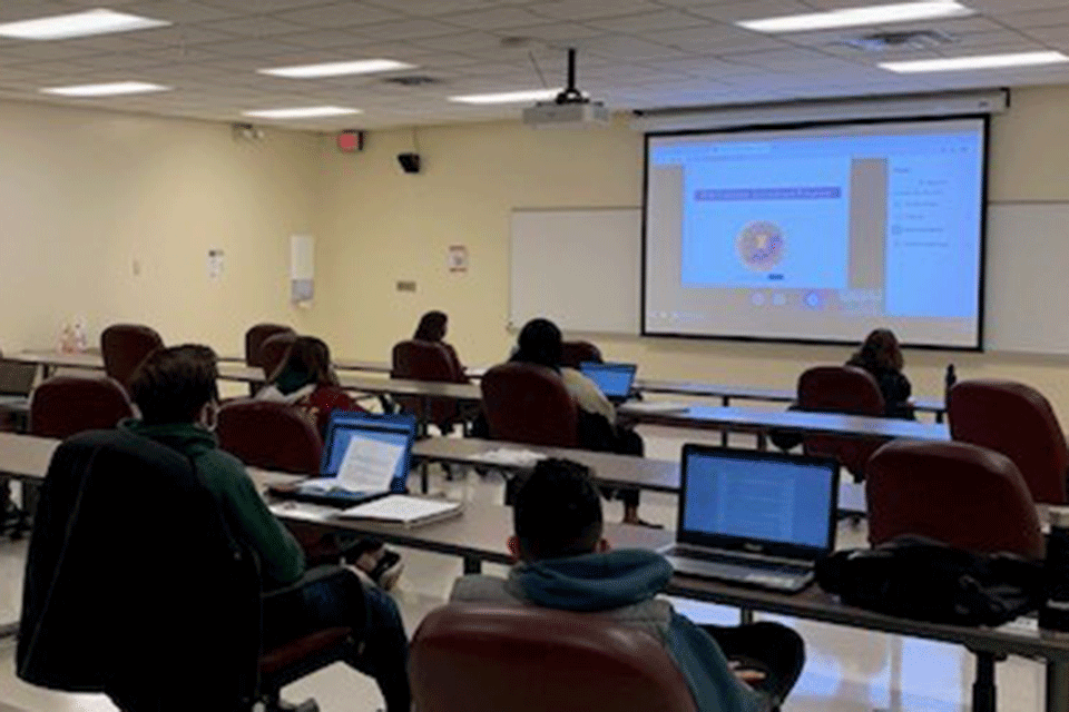 MBA students interact with an FBI forensic accountant.