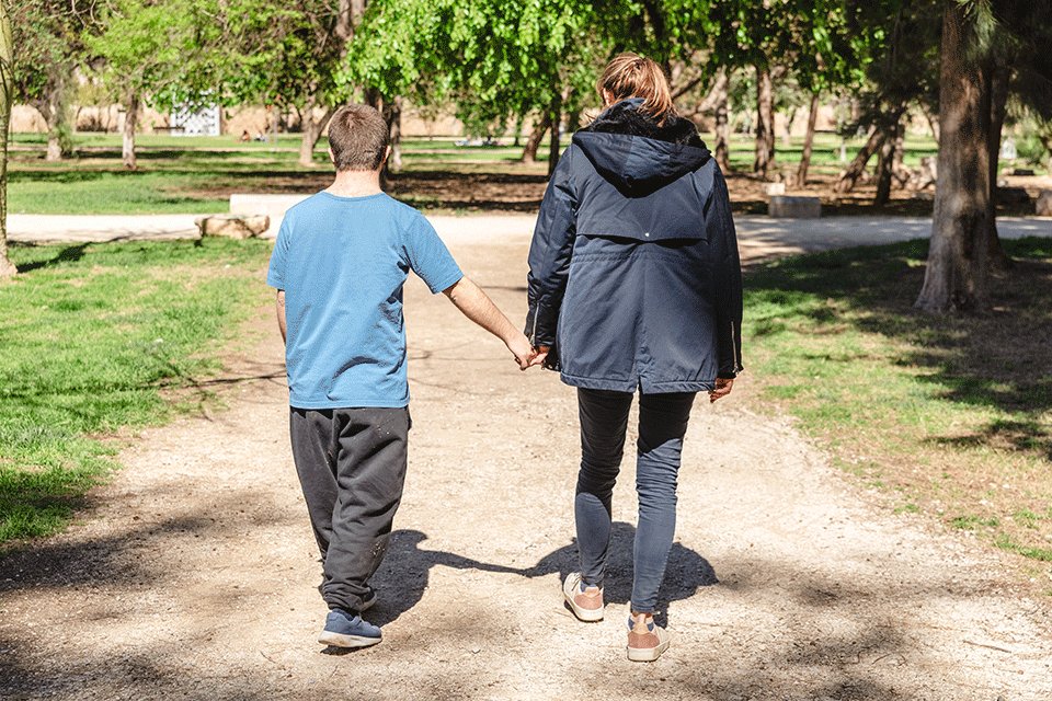 Two people walking outside.