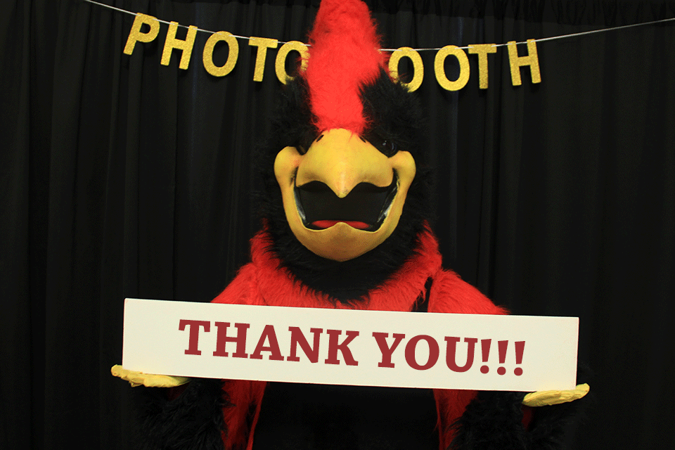 Cardinal holds a sign that reads Thank You.