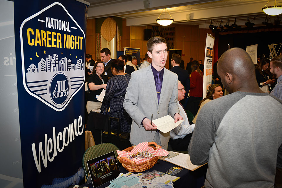 A student talks with a potential employer about career opportunities.