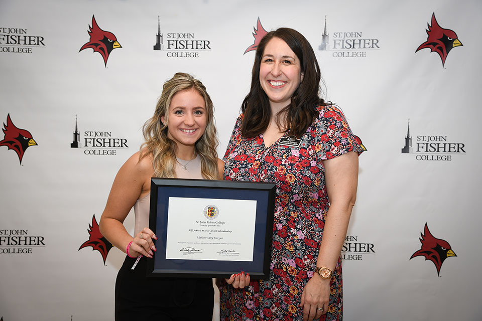 Amanda Metzger presents senior Madison Mary Morgan with the 2022 John A. Murray Award in Leadership.