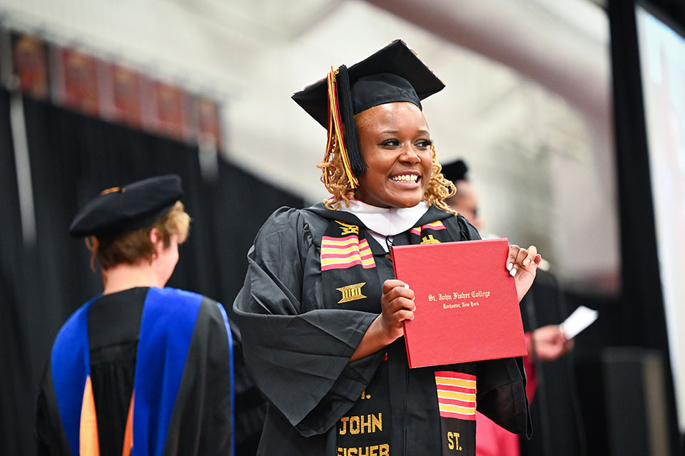 A proud graduate of the School of Arts and Sciences crosses the stage.