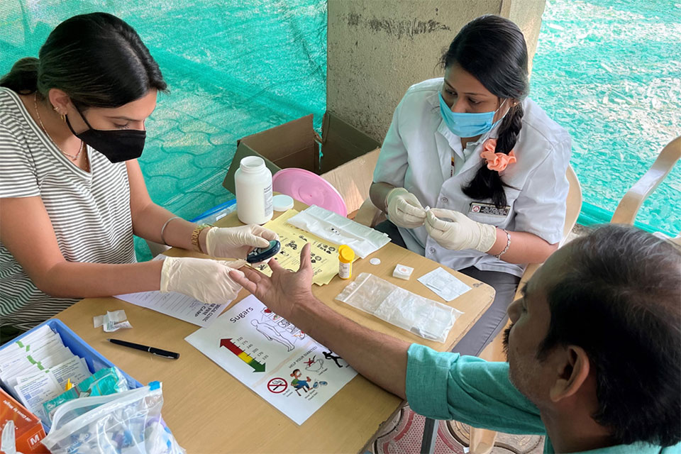 Members of the pharmacy team staff a medical clinic in Pune, India.