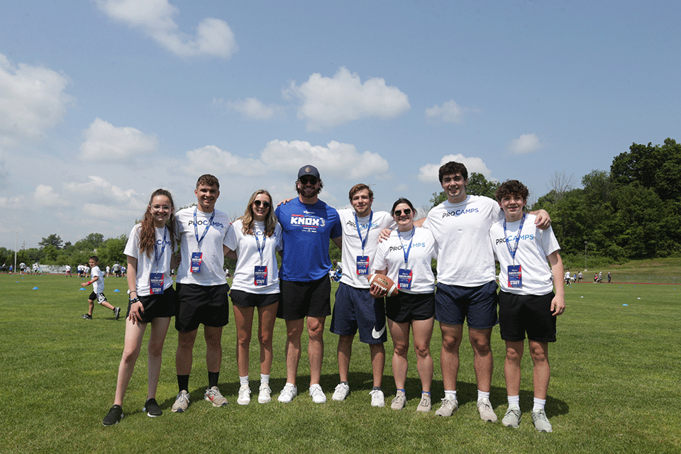 Students volunteer at football camp hosted by Buffalo Bills player Dawson Knox.