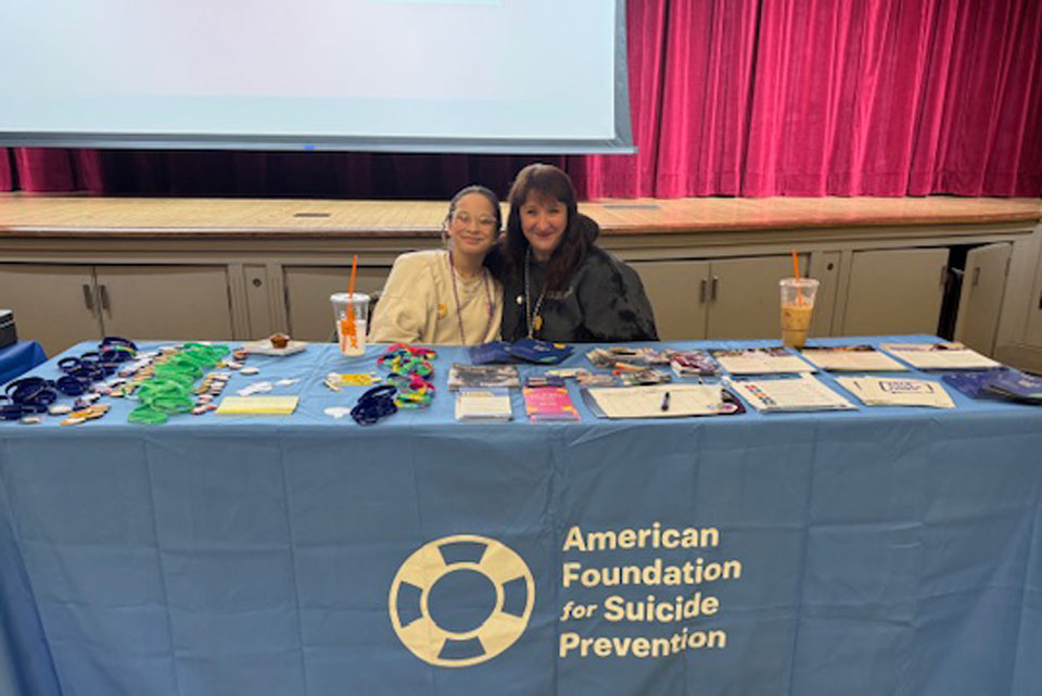 A board member from AFSP shares information at the 2025 Out of the Darkness Walk.