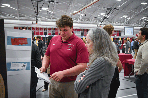 A student shares research with Dr. Eileen Lynd-Balta during the annual Fisher Showcase