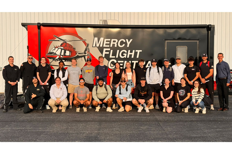 Students from the School of Business with the Mercy Flight crew.