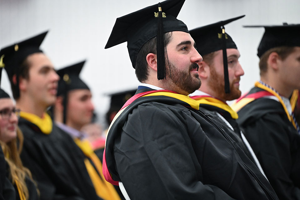 A graduate of one of Fisher's master's degree programs celebrates at Commencement.