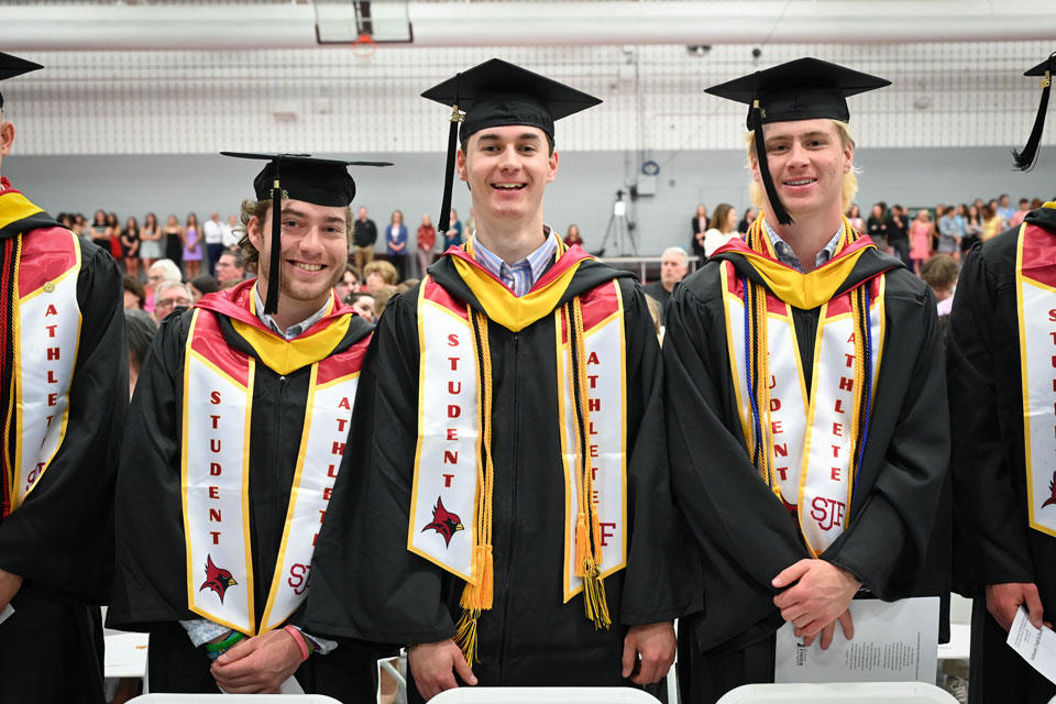 Three graduates at the Athlete Commencement Ceremony.
