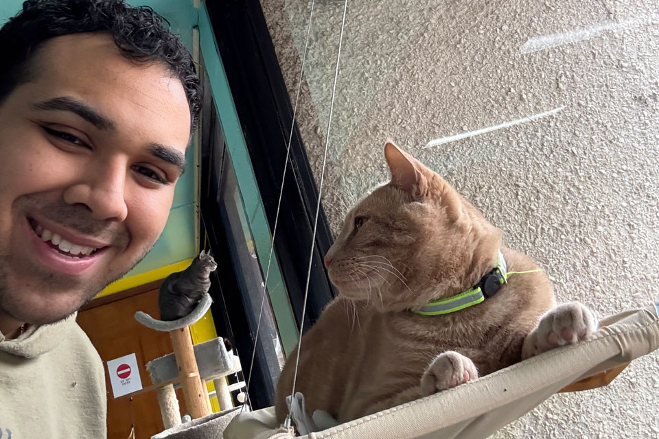 Pharmacy student Gabrial Moncayo volunteers at an animal shelter with cats.